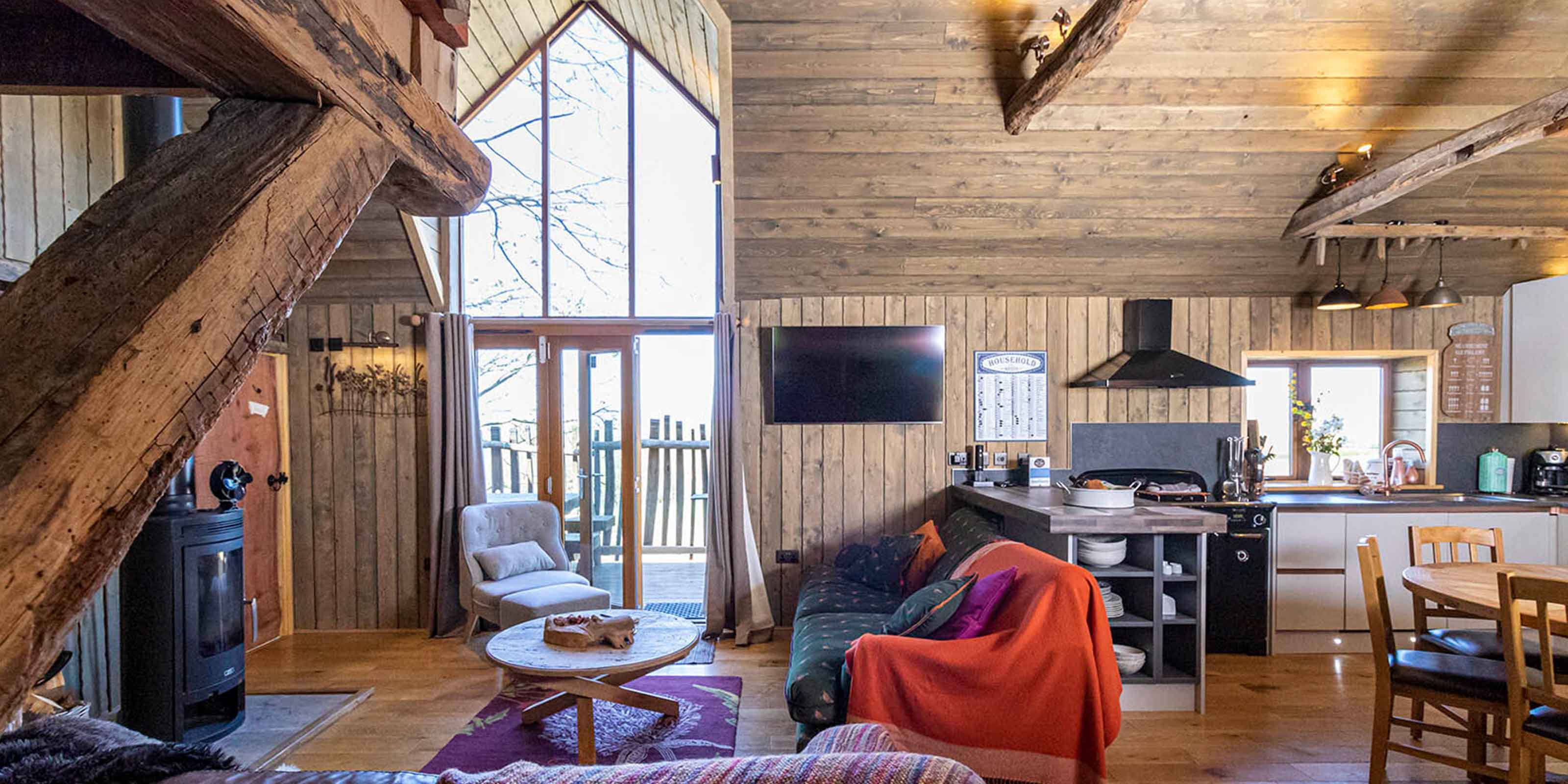 Interior of our treehouse breaks with window view of luxury tree house holidays. 